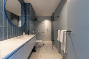 a bathroom with a sink and a toilet and a mirror at Quarter 411 in Cape Town +10 photos