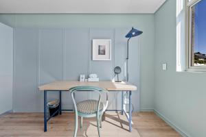 a desk with a chair and a lamp in a room at Quarter 411 in Cape Town