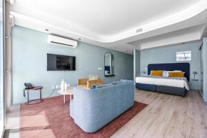 a living room with a bed and a couch at Quarter 411 in Cape Town