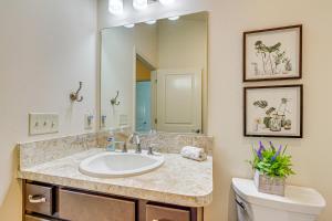 a bathroom with a sink and a toilet and a mirror at Golf, Shop and Unwind Lovely Home in The Villages! in The Villages +16 photos