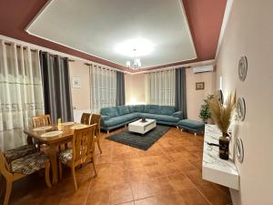 a living room with a couch and a table at THE DOMI Apartments in Durrës