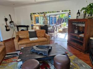 a living room with a couch and a table at Spacious home in Cape Towns Blouberg area in Cape Town