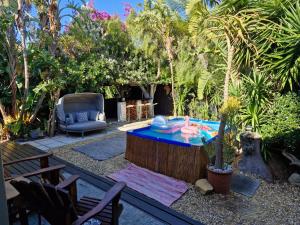 a patio with a table and a chair in a yard at Spacious home in Cape Towns Blouberg area in Cape Town