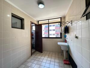 a bathroom with a sink and a window at Ap 3 quartos praia grande vista pro mar área nobre in Ubatuba +7 photos