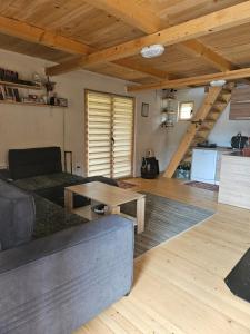 a living room with a couch and a table at Zelena čarolija in Bioštica