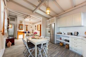 a kitchen and dining room with a table and chairs at Lindos Seaside Villa in Lindos