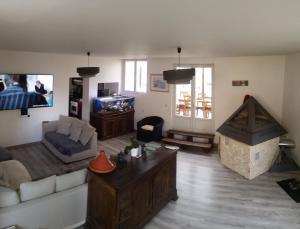 a living room with a couch and a fireplace at Les 2 Alpes in Puget-Théniers