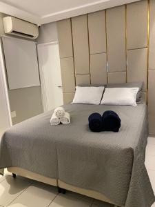a bedroom with a bed with two towels on it at Apartamento Bessa Luxo in João Pessoa