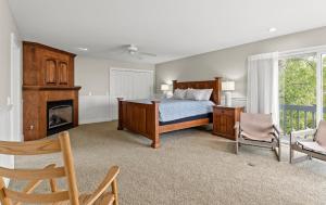 a bedroom with a bed and a fireplace at Beachside Getaway private Lake Michigan Beach Frontage in Spring Lake