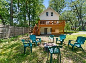 a group of chairs and a table in front of a house at Captain in Spring Lake