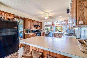 a kitchen with a large white counter top and wooden cabinets at Cozy and Tranquil Creekfront Cottage in Litchfield in Pawleys Island