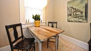 a dining room with a wooden table and chairs at Chic 1 BR Units Near Dilworth in Charlotte