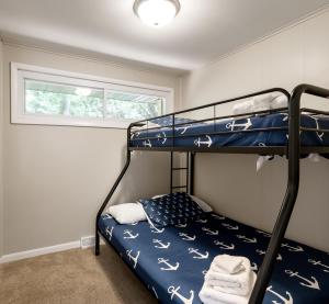 a bedroom with a bunk bed and a window at Dunes Edge- Private Silver Lake Home in Mears