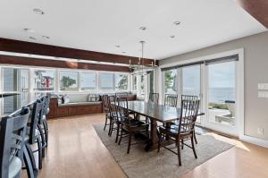 a dining room with a table and chairs at Dreamview- Private Lake frontage in Spring Lake