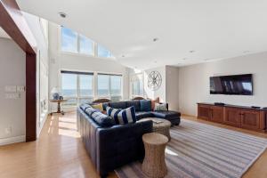 a living room with a couch and a tv at Dreamview- Private Lake frontage in Spring Lake