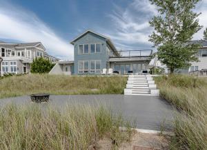 a house with a pond in front of it at Dreamview- Private Lake frontage in Spring Lake