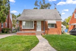 a red brick house with a white door at Cozy 4 Bedroom-Outdoor furniture- 2 bathrooms in Dearborn Heights