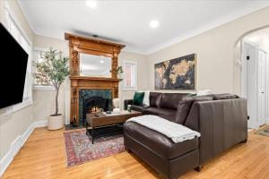 a living room with a couch and a fireplace at 4 Bedroom 2 Bath Middle of it all Sleeps 8 in Dearborn