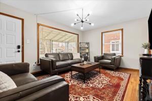 a living room with two couches and a table at Near Greenfield Village-Downtown Dearborn-Oakwood in Dearborn