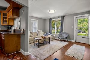 a living room with a couch and a table at Cozy 3 Bedroom Near Airport And Downtown Detroit in Dearborn Heights