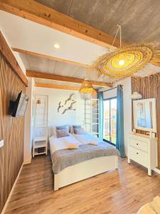 a bedroom with a bed and a television in it at Apartamentos de la Huerta in Alicante +62 photos