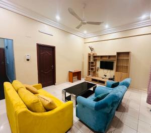 a living room with two couches and a tv at Résidence Nana Baco Djicoroni in Bamako +48 photos