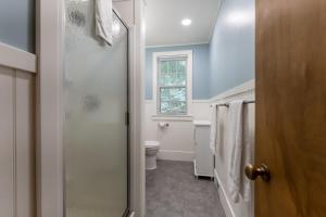a bathroom with a toilet and a window at Red Cottage Cute Holland cottage walk to beach in Holland +13 photos