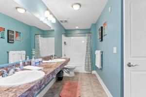 a bathroom with two sinks and a toilet at Experience comfort at Quill Haven - Pet Friendly in Grand Haven +34 photos