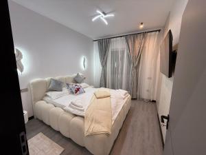 a small bedroom with a bed and a window at EVO Apartament de Lux André in Sibiu