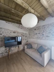 a living room with a couch and a flat screen tv at fuerte trece in Encinasola