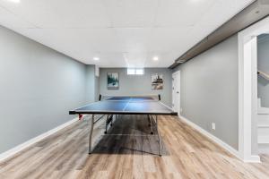a ping pong room with a ping pong table at Private pool, close to Lake Michigan Beaches in Muskegon