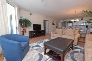 a living room with a couch and a table at Whitney Parish Retreat Beachfront Bliss in Pawleys Island
