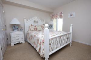 a white bedroom with a white bed and a window at Whitney Parish Retreat Beachfront Bliss in Pawleys Island