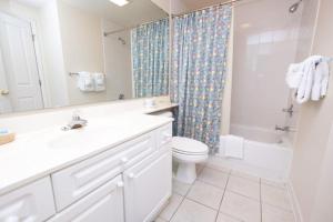 a bathroom with a sink and a toilet and a shower at Whitney Parish Retreat Beachfront Bliss in Pawleys Island +8 photos