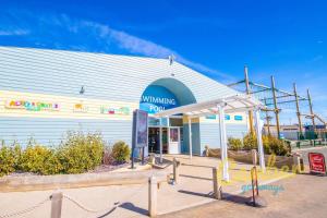 a building with a sign in front of it at MP303 Parkdean Camber Sands in Camber +6 photos