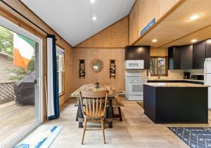 a kitchen with a table and a dining room at Experience the charm of Silver Lake at Parrothead Retreat in Mears