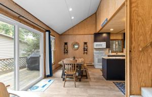 a kitchen and dining room with a table at Experience the charm of Silver Lake at Parrothead Retreat in Mears