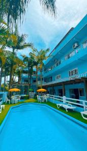 a large swimming pool in front of a building at Pousada Bella Praia in Torres