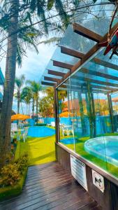 a house with a deck with a swimming pool at Pousada Bella Praia in Torres