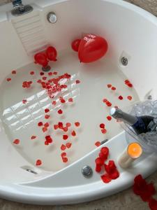 a white table with red hearts and blood on it at Pousada Bella Praia in Torres