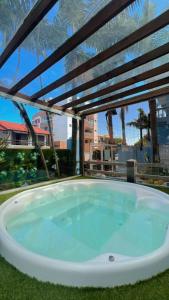 a jacuzzi tub on a patio with a view at Pousada Bella Praia in Torres