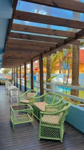 a group of chairs and tables on a deck at Pousada Bella Praia in Torres
