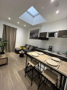 a kitchen and a living room with a skylight at Beautiful T3, 6 people, Paris-Est, free parking in Bagnolet +11 photos