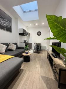 a living room with a couch and a skylight at Beautiful T3, 6 people, Paris-Est, free parking in Bagnolet