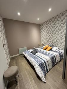 a bedroom with a bed with yellow pillows and a chair at Beautiful T3, 6 people, Paris-Est, free parking in Bagnolet