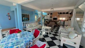 a living room with a table and chairs at Pousada Bella Praia in Torres