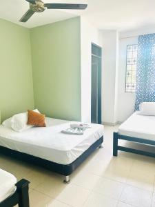 a bedroom with two beds and a ceiling fan at Laurel plaza 46 in Montería +20 photos
