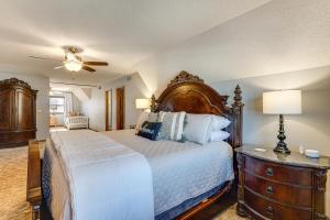 a bedroom with a large bed with a wooden headboard at Lakefront Home with Dock and Decks in Gravois Mills! in Gravois Mills