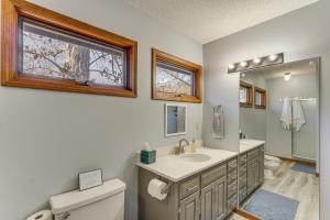 a bathroom with a sink and a toilet and a window at Lakefront Home with Dock and Decks in Gravois Mills! in Gravois Mills +35 photos