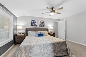 a bedroom with a bed and a ceiling fan at Hillside Cottage- Great Vacation Rental with Private Pool in Muskegon +22 photos
